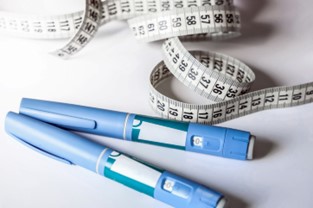 Two semaglutide injection pens next to a tape measure. | Medi-Weightloss