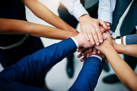 team huddle overhead shot of the hands only